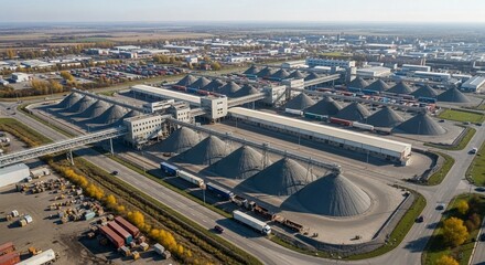 Obraz premium Aerial view of a vast industrial bulk commodity terminal with large storage silos and logistical infrastructure, showcasing global trade operations.
