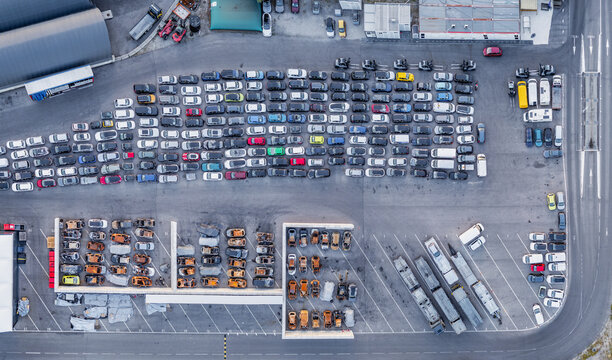 Livron-sur-Drome, France - 20 June 2026: Aerial view of an extensive vehicle storage facility featuring rows of parked cars, automated car stacking systems, and organized parking bays.