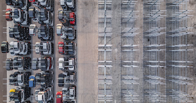 Livron-sur-Drome, France - 20 June 2026: Aerial view of an automated car storage facility with multi-level vehicle stacking racks and rows of parked automobiles.