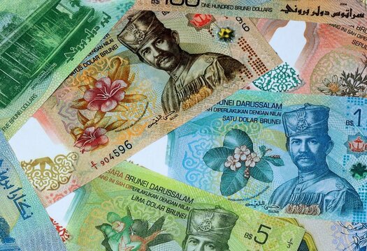 Brunei dollar money banknotes bunch on table. Brunei bills of BND currency close up