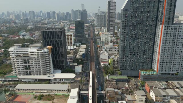Urban Bangkok Bang Chak Neighborhood Skytrain Travels To Next Station Drone Track Forward 4K 60FPS