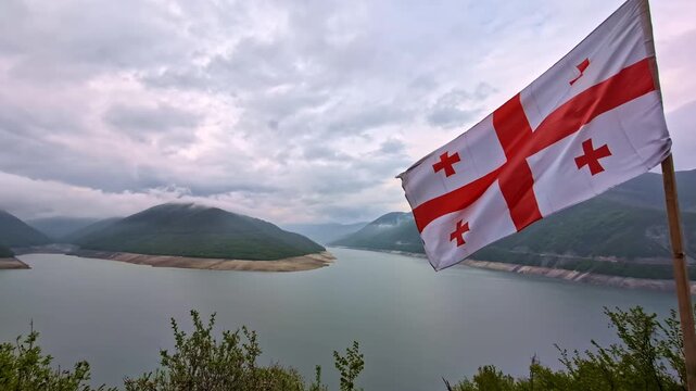 Georgian flag waving in the wind over the Zhinvali water reservoir near Tbilisi