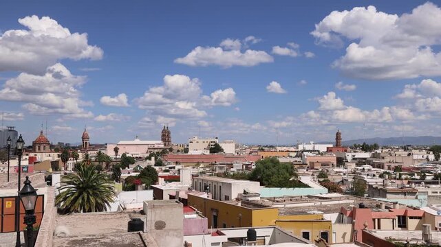 View of the historic city center with colonial architecture, church domes, and rooftops under a blue sky in Durango, Durango, Mexico.