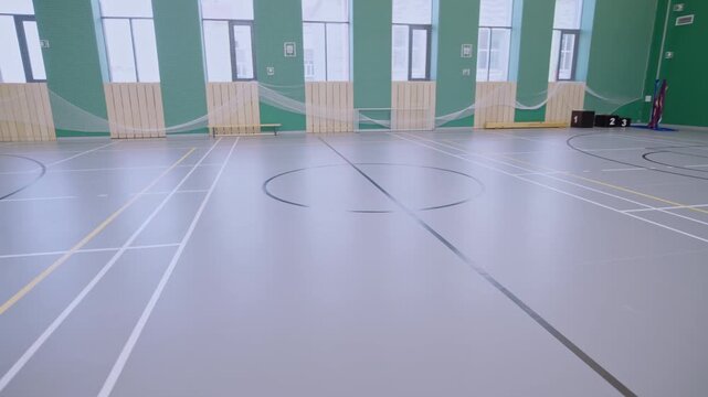 Athletic hall displays soccer goal structure and safety mesh netting. Stadium design offers disciplined atmosphere for physical training