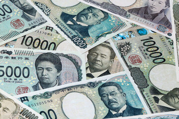 Japanese yen money bills in pile on table. Japan JPY currency cash close up © Viktor
