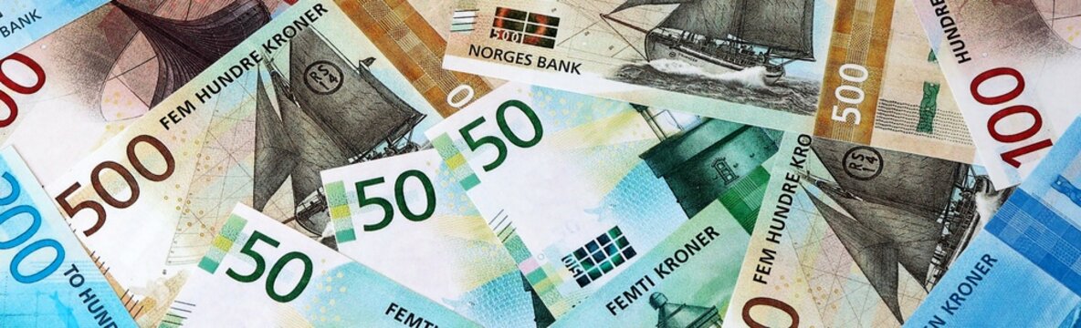 Norwegian krone money bills in pile on table. Norway NOK currency cash close up