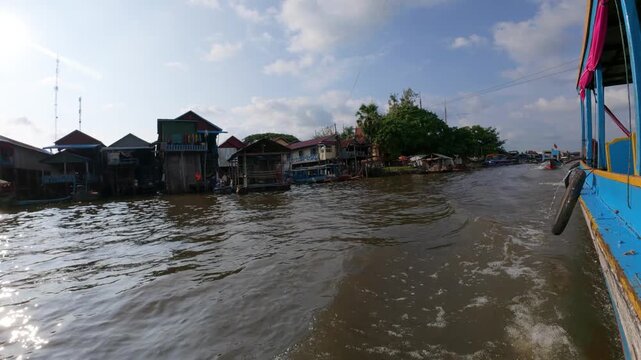 View of the Floating Village with wooden stilt houses along the river in Kampong Khleang, Siem Reap, Cambodia.