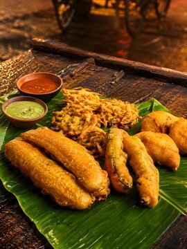 South Indian evening snacks bajji and pakoda on banana leaf.