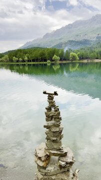 Peaceful Spring Landscape: Zen Stones and Forest Reflections on Water
