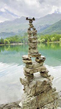 Tranquil Spring Scenery: Zen Rock Balancing and Majestic Lake Reflections