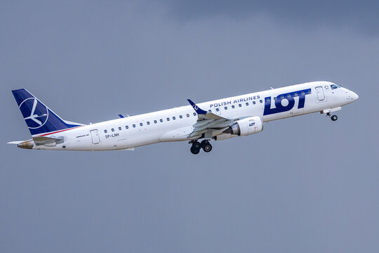 Ein Embraer 195 der LOT Polish Airlines (SP-LNH) steigt nach dem Start in bedecktem Himmel. 