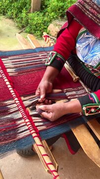 Indigenous artisan weaving traditional textile on a backstrap loom
