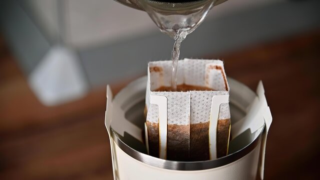 Pouring hot water into a coffee drip filter for brewing