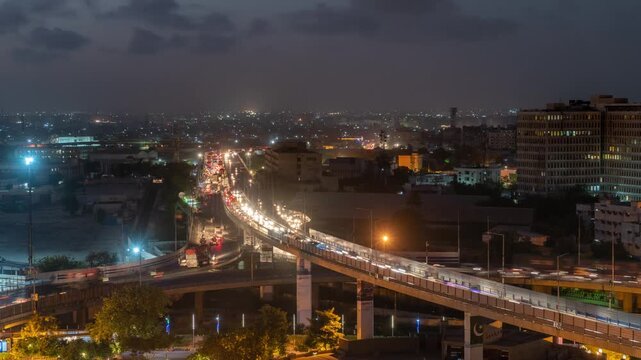 View of the illuminated Jinnah Flyover with heavy evening traffic flowing through the urban landscape of Karachi, Sindh, Pakistan.