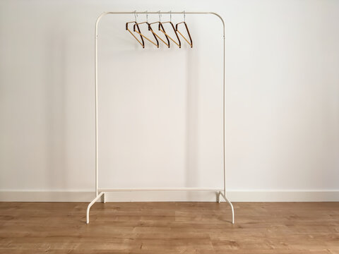 White Metal Clothes Rack with Bamboo Hangers, Angled View