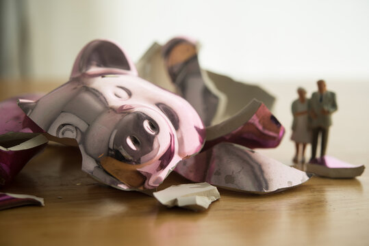 Senior couple are looking at broken piggy bank. No savings for retirement, poor, bankruptcy, financial problem, no financial planning for future, social issue, financial literacy and so on concept.
