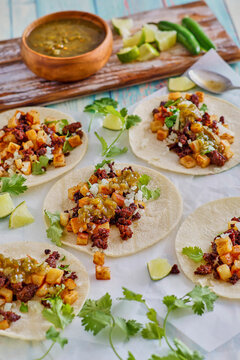 chorizo and potato tacos topped with fresh cilantro and lime juice