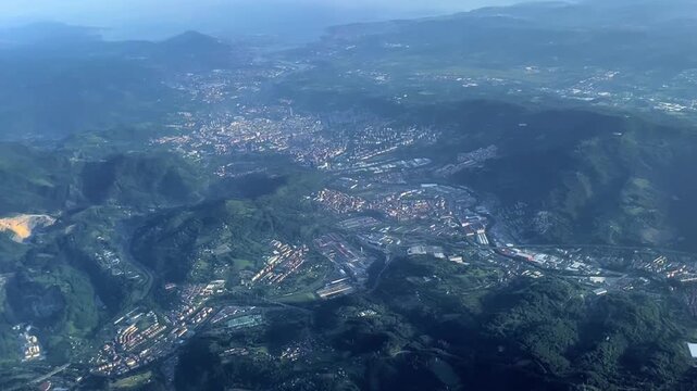 Aerial footage captured from an airplane flying over the Greater Bilbao metropolitan area in northern Spain