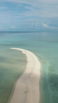Tropical beach with crystal clear water in the tropics. Timba Timba islet. Tun Sakaran Marine Park. Borneo, Sabah, Malaysia. Vertical video.