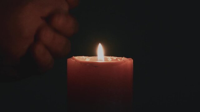 Warming hands in the dark with a candle flame