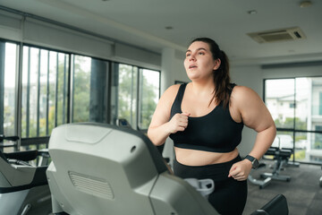 Fototapeta premium Plus Size Woman Running on Treadmill During Cardio Workout at Gym