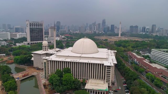 Aerial drone: Monas (National Monument) close frontal, Merdeka Square and Istiqlal behind