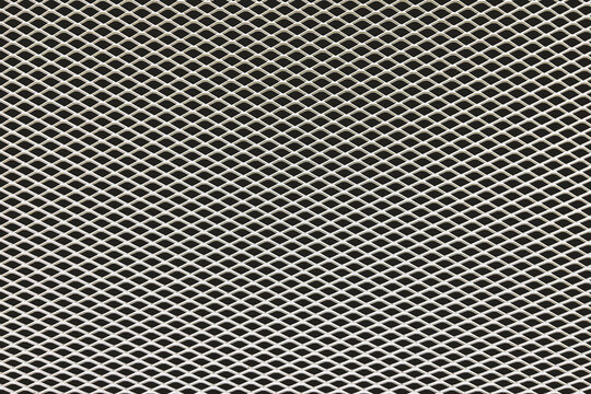 Close up of expanded metal mesh texture with geometric pattern. Industrial steel grid background for design, construction and technology concepts