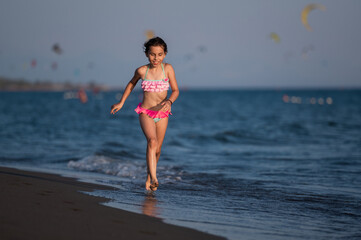 Fototapeta premium Girl running on beach enjoying summer vacation