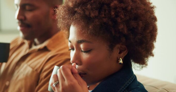 Woman, coffee and blowing in home with couple, cool drink or beverage n living room on off day. African person, partner and warm tea with calm, peace and rest on weekend break together at house