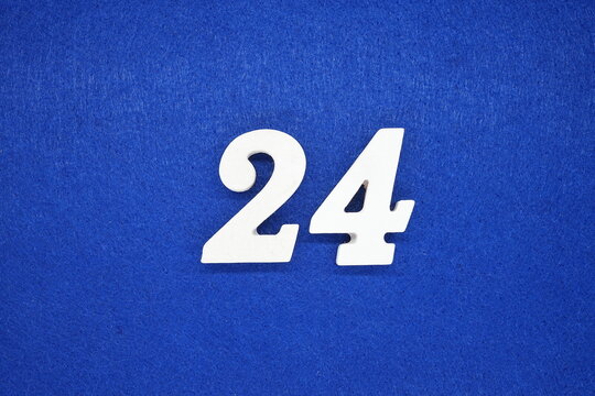 The numbers are made of wood, painted white, and placed on a blue background of paper.