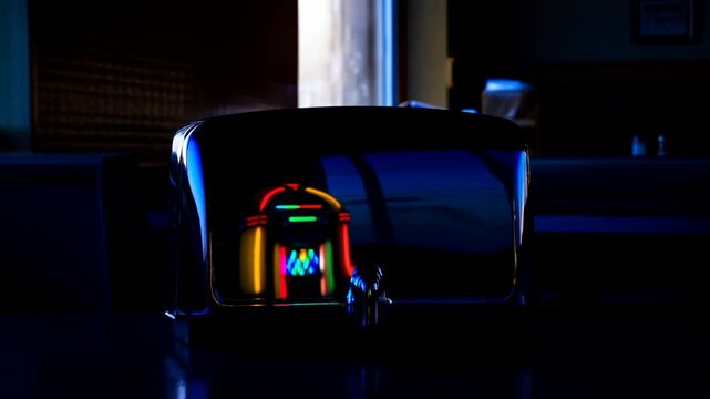 Retro diner tabletop sequence with chrome napkin dispenser reflecting jukebox and warm window