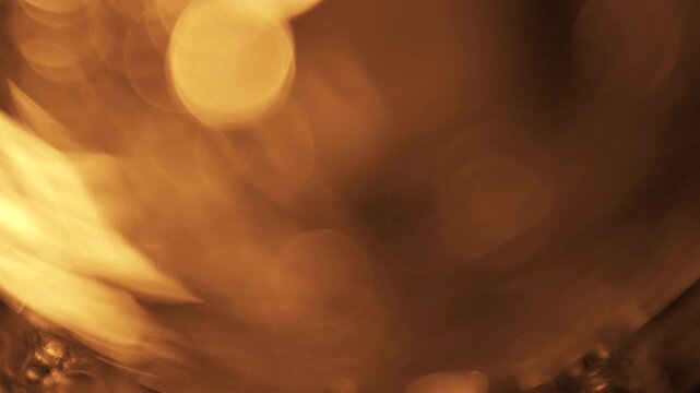 Golden light leak transition with warm cinematic lens flare bokeh overlay effect
