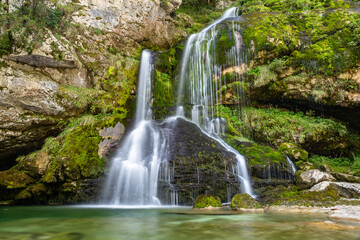 Fototapeta premium Long exposure of beautiful cascading Virje Waterfall in green nature, Slovenia, Europe