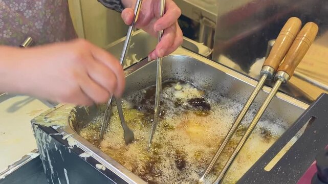 shanghai street vendor deep fries cabbage pastries in hot oil creating unhealthy fast food. oily shanghai fast food contains carcinogens from deep frying process. 