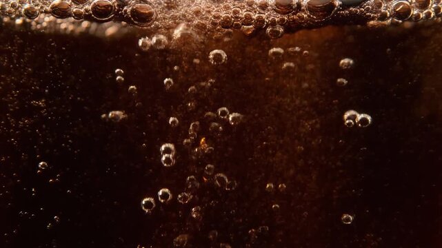 Macro Cinematic View of Carbonation Bubbles Rising in Dark Sparkling Cola Liquid, Professional Full HD Motion Background