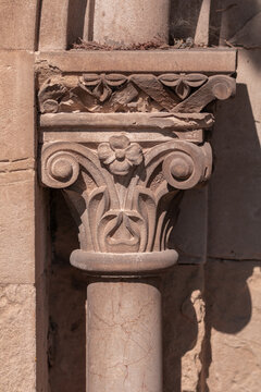 elements of architectural decorations of buildings, ancient arches and columns, pommel and patterns, on the streets in Barcelona, public places.