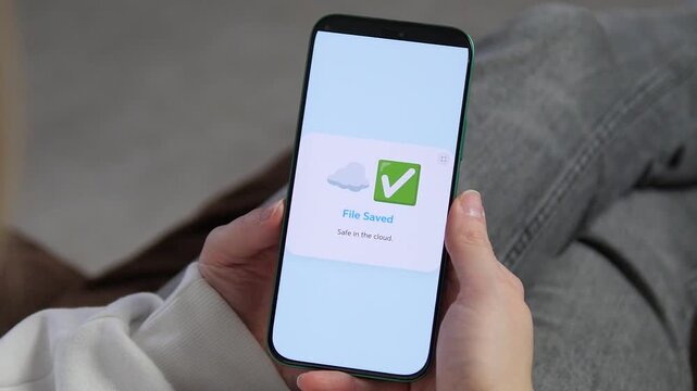 Seamless cloud syncing in action. A user uploads 45 items to the cloud on a modern smartphone. Features realistic app interface with a successful green checkmark. Perfect for software reviews, tech