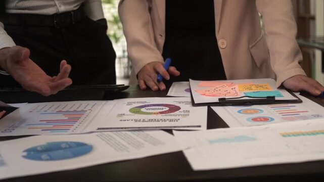 Business professionals analyzing financial data reports and charts together finance analysis meeting chart report