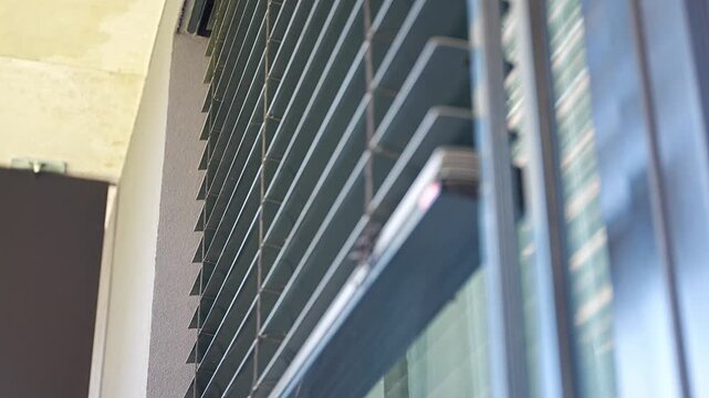 Exterior window blinds automatically opening to let natural daylight into a modern apartment. Smart home automation and energy efficient living concept.