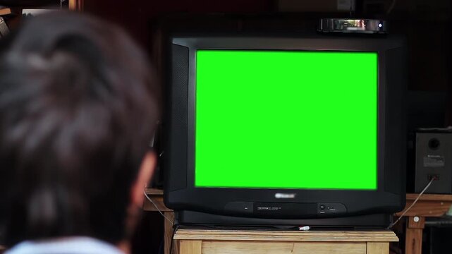 Zoom In Shot of Man in Living Room Watching Retro TV Mockup Display - 4K