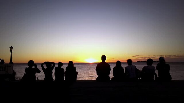 Group Of People Silhouettes Watching Sunset Over Sea In Colonia Uruguay - 4K