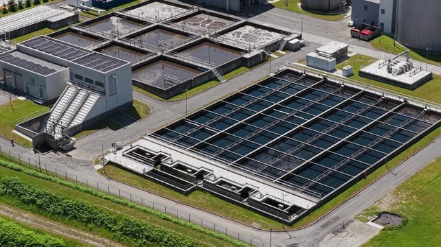 Aerial view of a wastewater treatment facility showing settling tanks and filtration systems for urban water management.