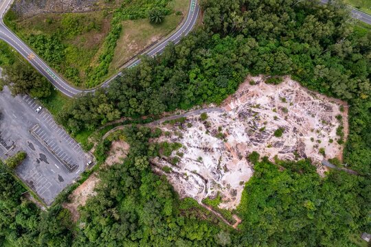 Aerial view of forest clearing near roads, showing land conversion, habitat fragmentation, and deforestation impacts.