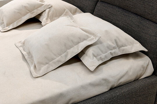 Close up fabric texture of soft beige pillows on bed