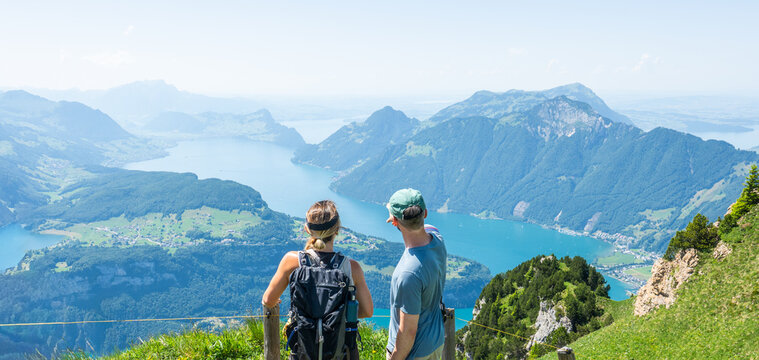 Hikers appreciating scenic view over vierwaldst&auml;ttersee in switzerland