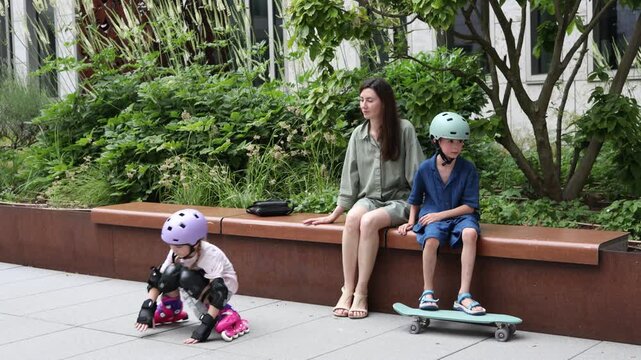 Children enjoy outdoor activities with roller skates and skateboard