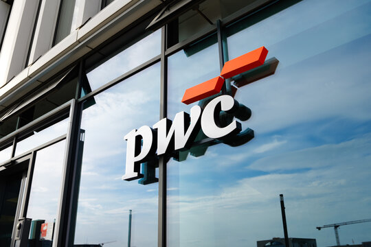 BERLIN, GERMANY - 16. June 2026: PwC logo sign close-up on office building exterior. PricewaterhouseCoopers company signage. Professional advisor and consultant company from outside.