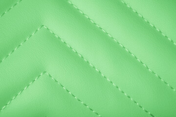 Naklejka premium Vibrant lime green quilted artificial leather material surface with precise diagonal stitching