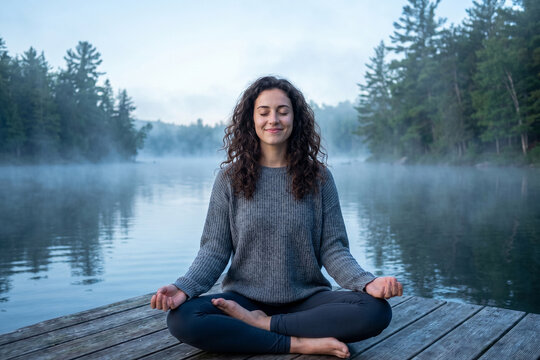 Smiling Woman Meditating by Misty Forest Lake Outdoors