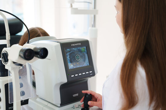 2026.06.08, Russia. Optometrist operating a Huvitz autorefractor device